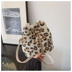 Detail of leopard print plush bucket bag with golden chain and pearl drawstring charms