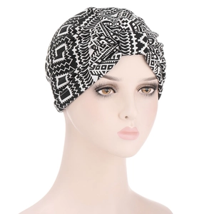 Detail of paisley pattern cotton headscarf with twisted knot design and geometric texture