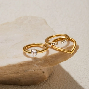 Three-piece gold plated steel ring set with pear cut zircon on natural stone