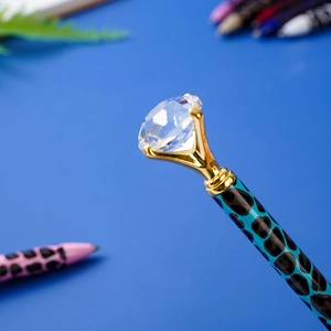 Blue leopard print metal ballpoint pen featuring a large crystal diamond topper on blue base