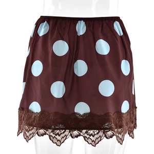 Detailed view of dark brown mini skirt featuring light blue polka dots and delicate lace trim