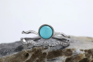 Detailed view of S925 silver gemstone rings set on stone with zircon and turquoise
