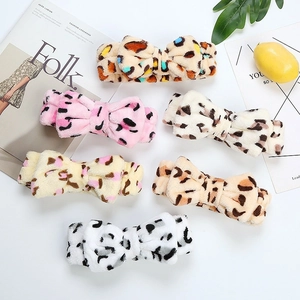 Detail showing various leopard print coral fleece headbands for washing face in soft colors