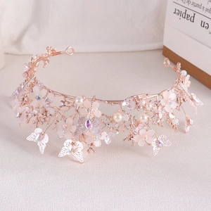Detail of rose gold bridal tiara with pearls, crystal flowers and butterfly motifs