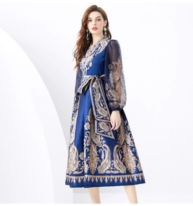 Close-up of vintage paisley print on long lantern sleeves of this blue maxi dress