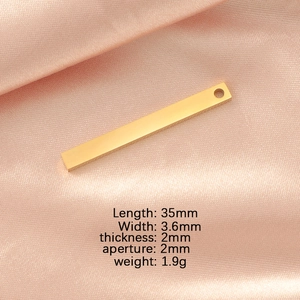 Polished gold rectangular bar pendant detail with dimensions on pink silk background