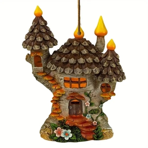 Hand-painted resin fairy tree house ornament with pinecone roof and hanging rope