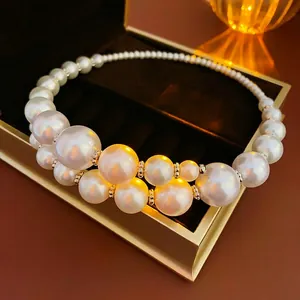 Elegant gradient faux pearl choker with metallic spacers displayed on a luxury jewelry box
