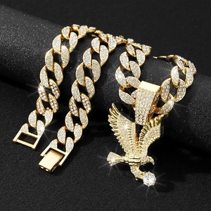 Gold-tone Cuban chain necklace with iced-out eagle pendant and clear crystal details