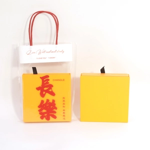Yellow square jewelry display box with clear gift bag and traditional Chinese calligraphy