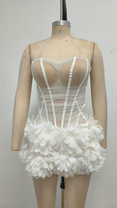 Detail of white strapless mesh dress with 3D floral petals and sheer bodice panel