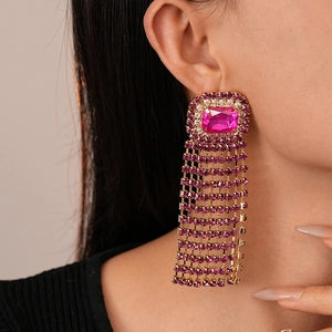Close-up of luxury vintage square fringe earrings with rose pink crystals on model