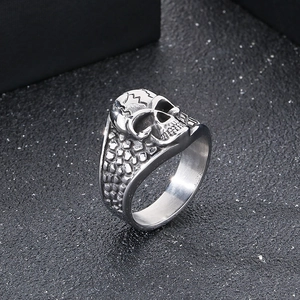 Close-up of gothic skull ring with vintage cracked texture and polished steel finish