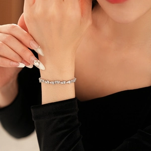 Detailed view of shimmering silver zircon row bracelet worn on wrist for an elegant look