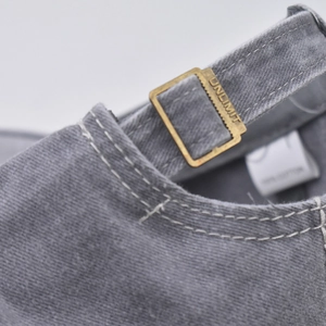 Close-up of vintage washed cotton baseball cap with adjustable brass buckle strap