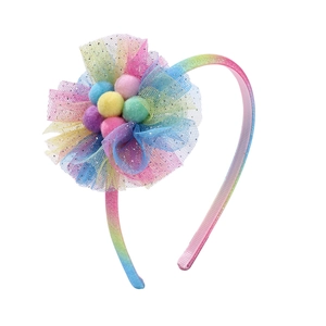 Glittery rainbow headband with gradient mesh flower and colorful pom-poms for girls