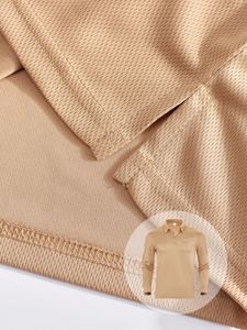 Close-up of khaki polo shirt showing breathable honeycomb mesh fabric and chest pocket