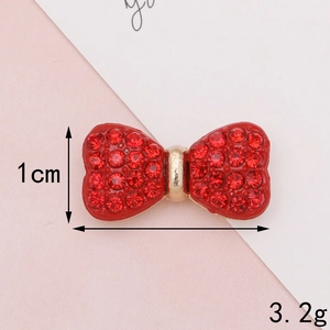 Detailed view of red rhinestone bow accessory with 1 cm height and 3.2g weight specs