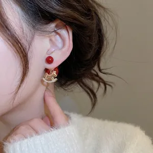 18K gold plated rocking horse earrings with red beads and shimmering zircon accents