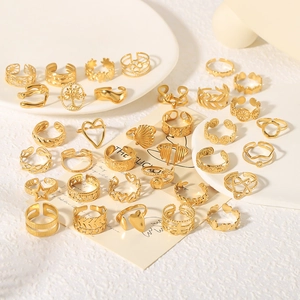 Golden stainless steel ring set featuring heart, star and geometric cutout designs