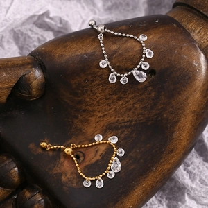 Detail of adjustable 18K gold plated bead rings with dangling clear faceted crystals