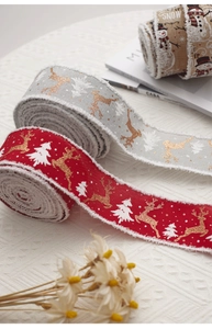 Detailed view of Christmas burlap ribbons with reindeer prints and fuzzy white edges