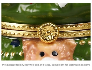Macro shot of green Christmas bear jewelry box featuring a golden metal snap button