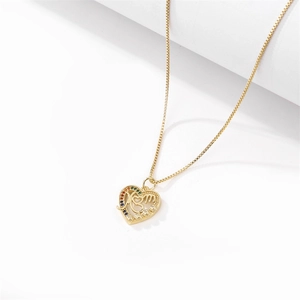 Macro shot of gold heart MOM pendant with colorful zircon stones on white background