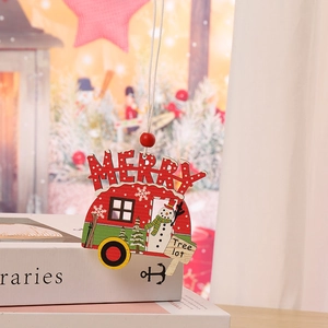 Detail of a red wooden camper ornament with Merry text and snowman for Christmas tree decor
