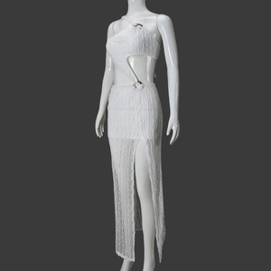 Detailed side view of white knitted two-piece set with crop top and high slit maxi skirt