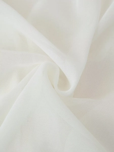 Close-up of white translucent chiffon fabric with soft draping and delicate texture