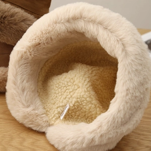 Detailed macro view of plush bucket hat featuring warm fleece lining and soft faux fur material