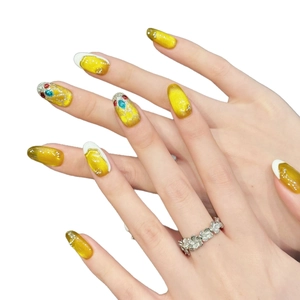 Golden cat eye press-on nails with luxury colorful gemstones inspired by power gauntlet