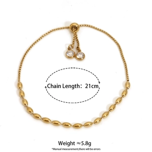 Detail of adjustable gold bead bracelet showing 21cm length and zircon charm details