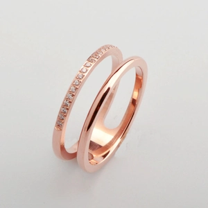 Detail of rose gold double-layer ring featuring one smooth band and one micro-paved band