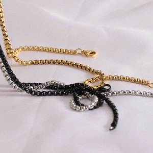 Close-up of 19mm soccer box chain necklaces in gold, silver, and black with lobster clasps