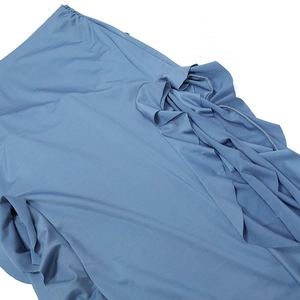 Detailed view of the soft blue fabric texture and drapery of a strapless vacation dress