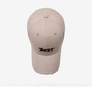 Top view of beige cotton baseball cap with BEST embroidery and distressed brim details