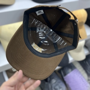 Premium dark brown cotton baseball cap with adjustable black strap and internal lining