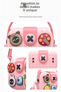 Detail of pink silicone toddler crossbody bag featuring 3D cartoon charms and adjustable strap
