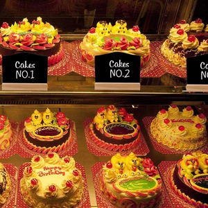 Close-up of mini wooden chalkboard sign on T-stand used for bakery food display