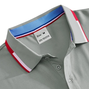 Detail of grey polo shirt collar with red, white, and blue stripes and M size label
