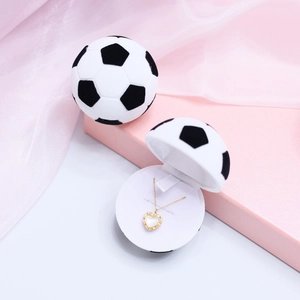 Creative soccer-shaped jewelry box with golden heart necklace inside for unique gift storage