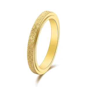 Minimalist spinning gold stainless steel ring with elegant matte frosted finish on white surface
