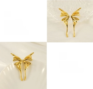 Detail of gold butterfly wing earrings featuring mirror polishing and plating textures