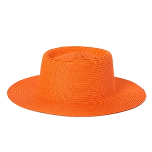 Detailed texture of vibrant orange woven straw boater hat with flat top and wide brim