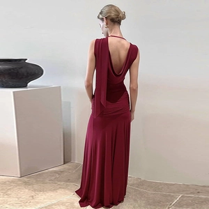 Detail view of the elegant backless burgundy dress with ruching and draped neckline