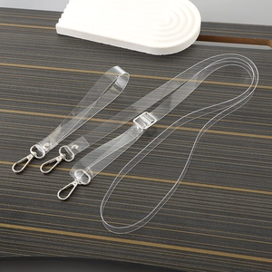 Minimalist transparent TPU phone lanyard chains with metal clasps on a dark wood surface