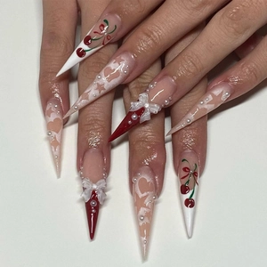 Extra long stiletto press-on nails with cherry art and 3D bows in pink and red