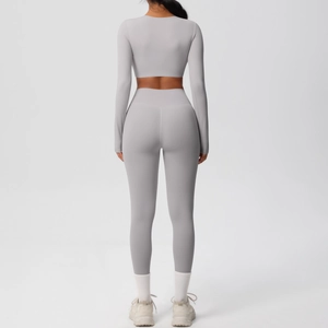 Rear view of lavender grey yoga set with long sleeve crop top and high waist leggings